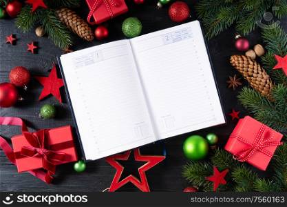 Christmas flat lay frame with red git boxes, Christmas celebration and gift giving concept, copy space on blank agenda pages. Christmas flat lay scene with golden decorations