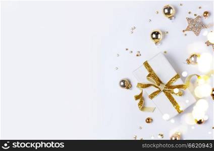 Christmas flat lay scene with git box with golden bow knot. Christmas flat lay scene with golden decorations
