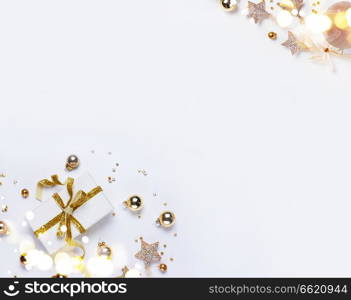 Christmas flat lay scene with git box with golden bow knot. Christmas flat lay scene with golden decorations