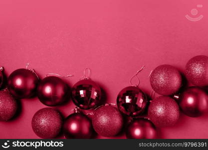 Christmas flat lay scene with glass balls in viva magenta color, copy space. Christmas flat lay scene with glass balls