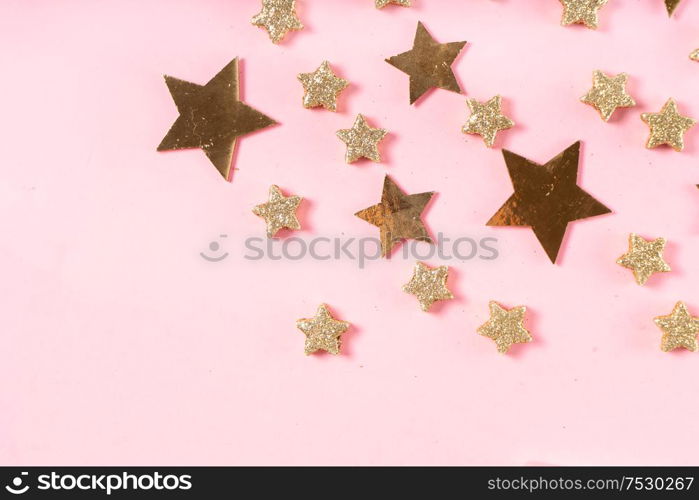 Christmas flat lay scene with golden decorations, top view with copy space on pink. Christmas flat lay scene with golden decorations