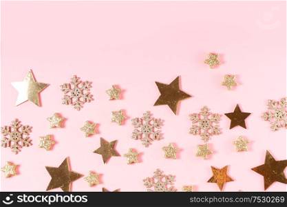 Christmas flat lay scene with golden decorations, top view with copy space on pink background. Christmas flat lay scene with golden decorations