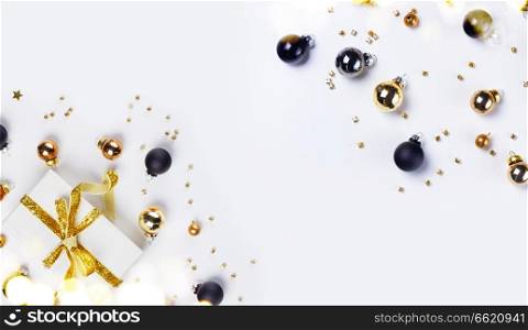 Christmas flat lay scene with golden, gray and black glass balls, banner with copy space. Christmas flat lay scene with glass balls