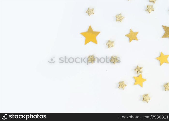 Christmas flat lay scene with golden stars and decorations, top view over white. Christmas flat lay scene with golden decorations