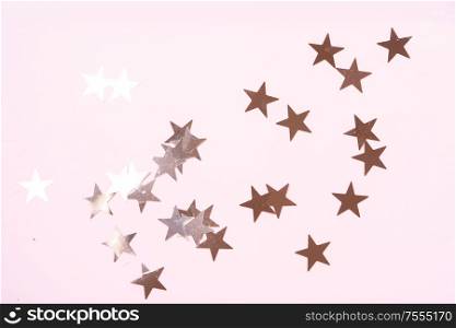 Christmas flat lay scene with golden stars, top view over pink. Christmas flat lay scene with golden decorations