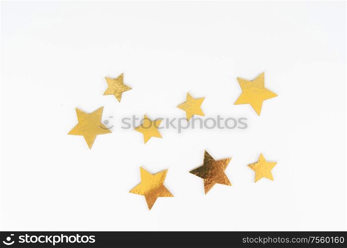 Christmas flat lay scene with golden stars, top view over white. Christmas flat lay scene with golden decorations