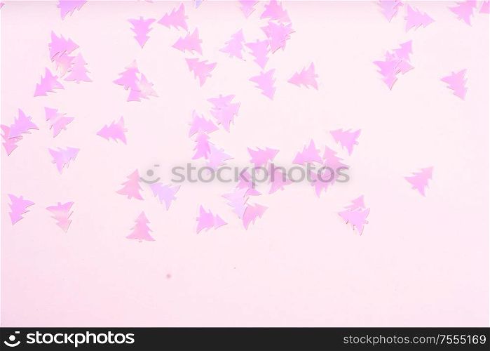 Christmas flat lay scene with pink fir tree confetti boder, top view over pink. Christmas flat lay scene with golden decorations