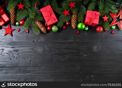 Christmas flat lay scene with red git boxes border, Christmas celebration and gift giving concept, copy space on wooden background. Christmas flat lay scene with golden decorations