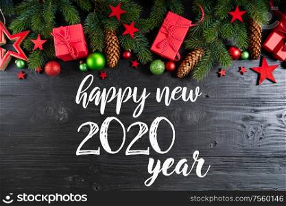 Christmas flat lay scene with red git boxes border, Christmas celebration and gift giving concept, copy space on wooden background with happy new 2020 year greetings. Christmas flat lay scene with golden decorations