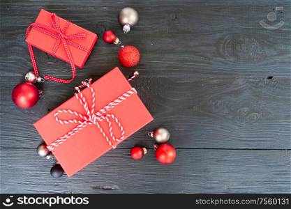 Christmas flat lay scene with red git boxes, Christmas celebration and gift giving concept, copy space on wooden background. Christmas flat lay scene with golden decorations