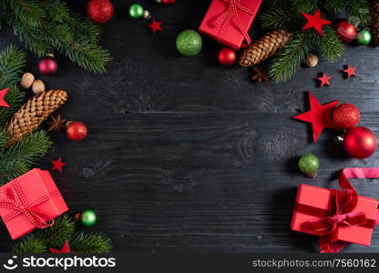 Christmas flat lay scene with red git boxes, Christmas celebration and gift giving concept, copy space on dark wooden background. Christmas flat lay scene with golden decorations