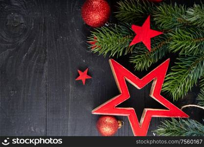 Christmas flat lay scene with red stars, Christmas celebration and gift giving concept, copy space on wooden background. Christmas flat lay scene with golden decorations