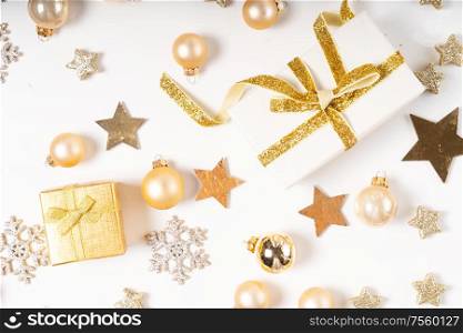Christmas flat lay scene with two git box with golden bow knot on white desk, top view. Christmas flat lay scene with golden decorations
