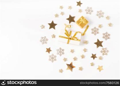 Christmas flat lay top view scene with two git box with golden bow knot, copy space on white desk background. Christmas flat lay scene with golden decorations