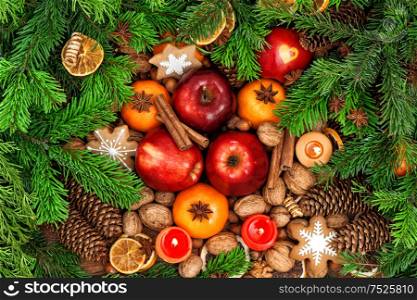 Christmas food backdround. Fruits, nuts, spices and cookies. Top view. Vibrant colors