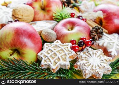 Christmas food background from the red apples, cookies and spices