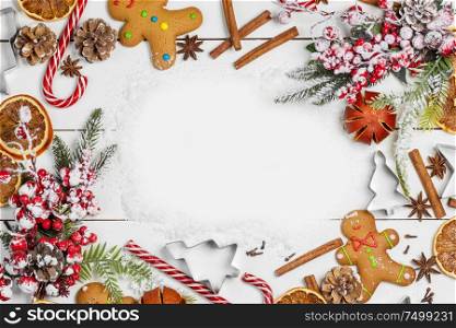 Christmas food frame. Gingerbread cookies, spices and decorations on white table background with copy space. Christmas food frame