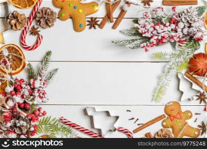 Christmas food frame. Gingerbread cookies, spices and decorations on white table background with copy space. Christmas food frame