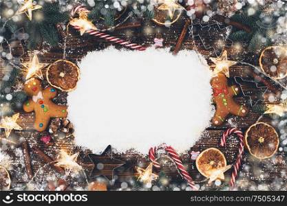 Christmas food frame. Gingerbread cookies, spices and decorations on wooden background with copy space on snow. Christmas food frame