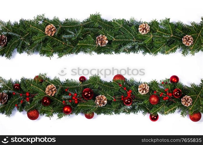 Christmas frame decor of fir tree branch cones red holly berry baubles isolated on white background. Christmas tree frame decor on white