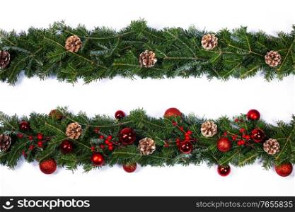 Christmas frame decor of fir tree branch cones red holly berry baubles isolated on white background. Christmas tree frame decor on white