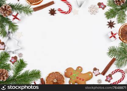 Christmas frame of decor on white, fir tree, gingerbread cookie and dandy canes on white background. Christmas decor on white background