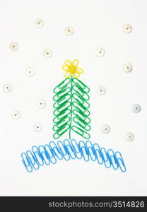 Christmas fur-tree from paper clips for a paper on a white background