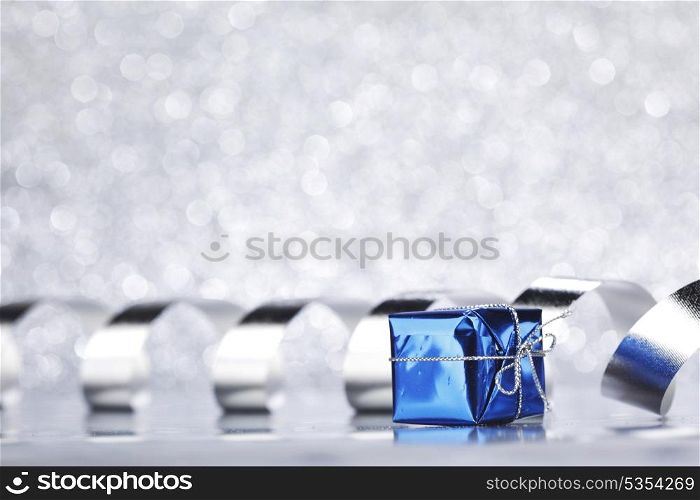 Christmas gift and decoration ribbon on shiny silver background