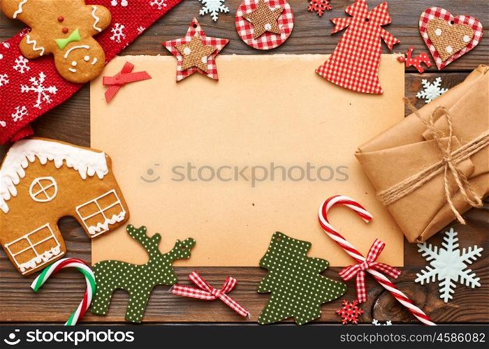 Christmas gift and homemade gingerbread cookie with handmade decoration on wooden background