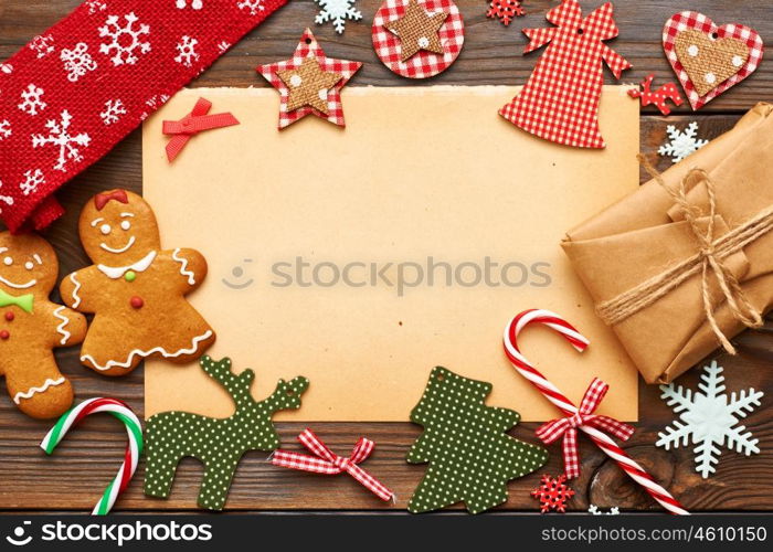 Christmas gift and homemade gingerbread cookie with handmade decoration on wooden background