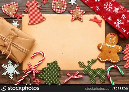 Christmas gift and homemade gingerbread cookie with handmade decoration on wooden background