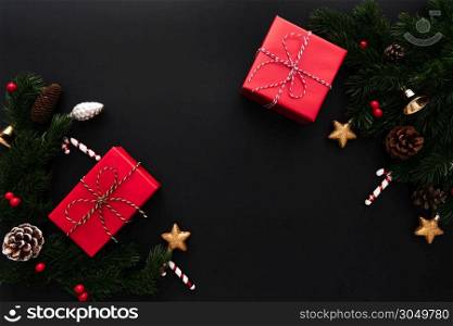 Christmas gift box and pine tree with xmas decoration on black background