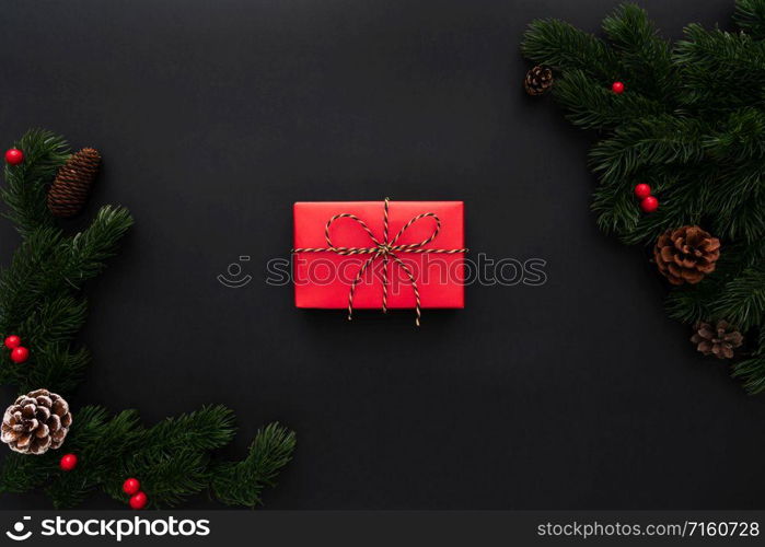 Christmas gift box and pine tree with xmas decoration on black background