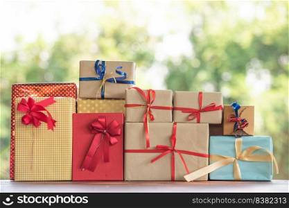 Christmas gift box blurred nature background with bokeh. green leaves bokeh out of focus background from nature forest.