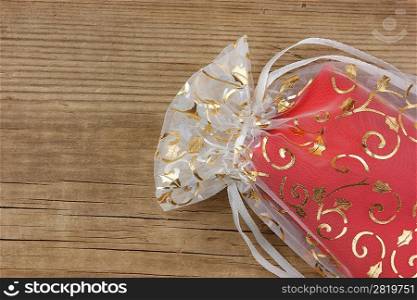 Christmas gift box on the old wooden background