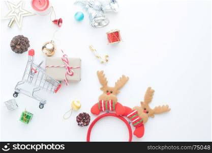 Christmas gift boxes, decorations and shopping cart on white background