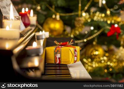 Christmas gift on piano. Christmas decoration with gift on piano