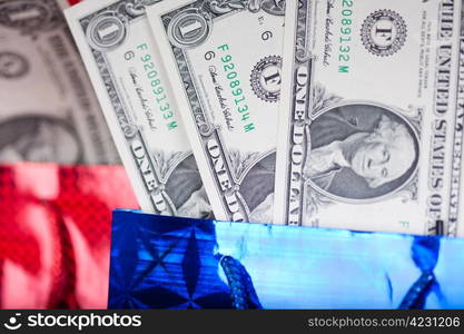 Christmas gift with dollars on abstract red background