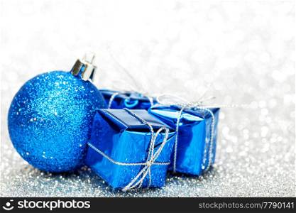 Christmas gifts and decorations on shiny glitter background