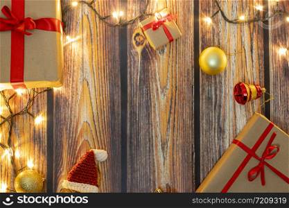 Christmas gifts and lights on wooden floor