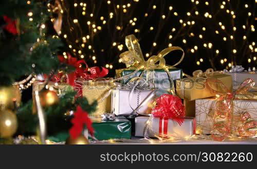 Christmas gifts near Christmas tree and atmospheric lights