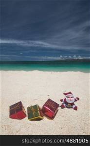 Christmas gifts on beach. Christmas gifts on the sand of tropical sea beach