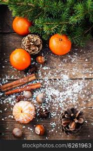Christmas gifts,tangerines,nuts and spices on wooden background