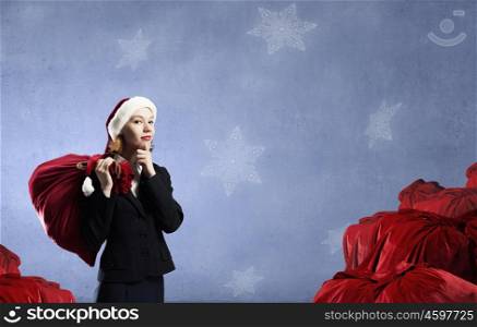 Christmas gifts. Thoughtful Santa woman with red gift bag on back