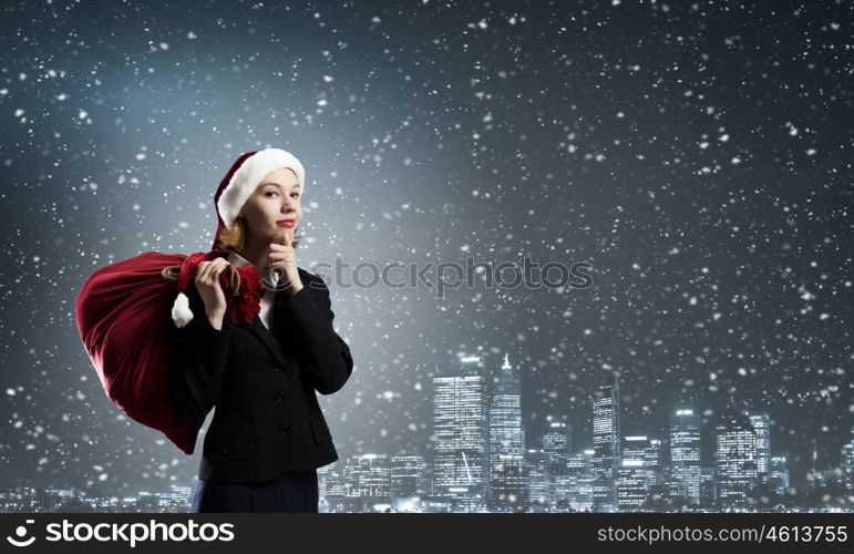 Christmas gifts. Thoughtful Santa woman with red gift bag on back