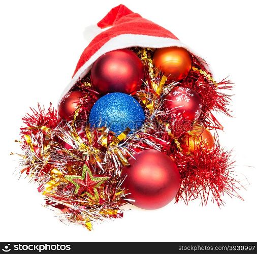 christmas gifts - xmas balls, star and decorations pour out from red santa hat on white background