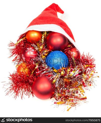 christmas giftsl - xmas balls and decorations fall out from red santa hat on white background