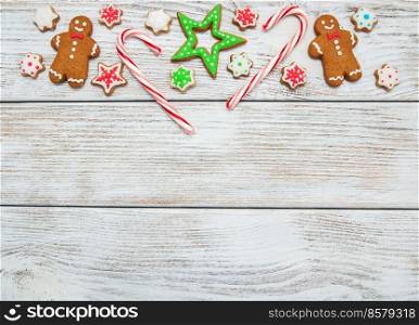 Christmas ginger and honey colorful cookies on a old wooden table