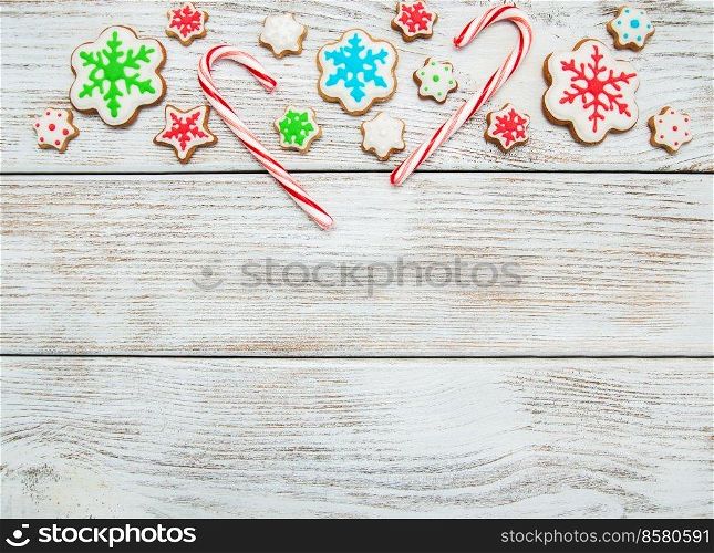 Christmas ginger and honey colorful cookies on a old wooden table