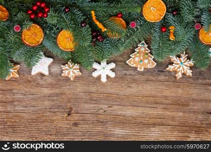 christmas gingerbread cookies. christmas gingerbread cookies with fir tree border on wood